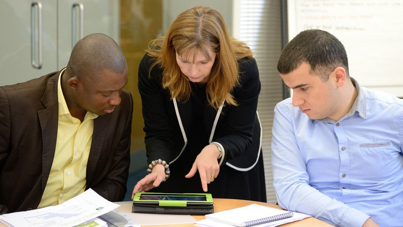 Three people collaborating in a meeting room